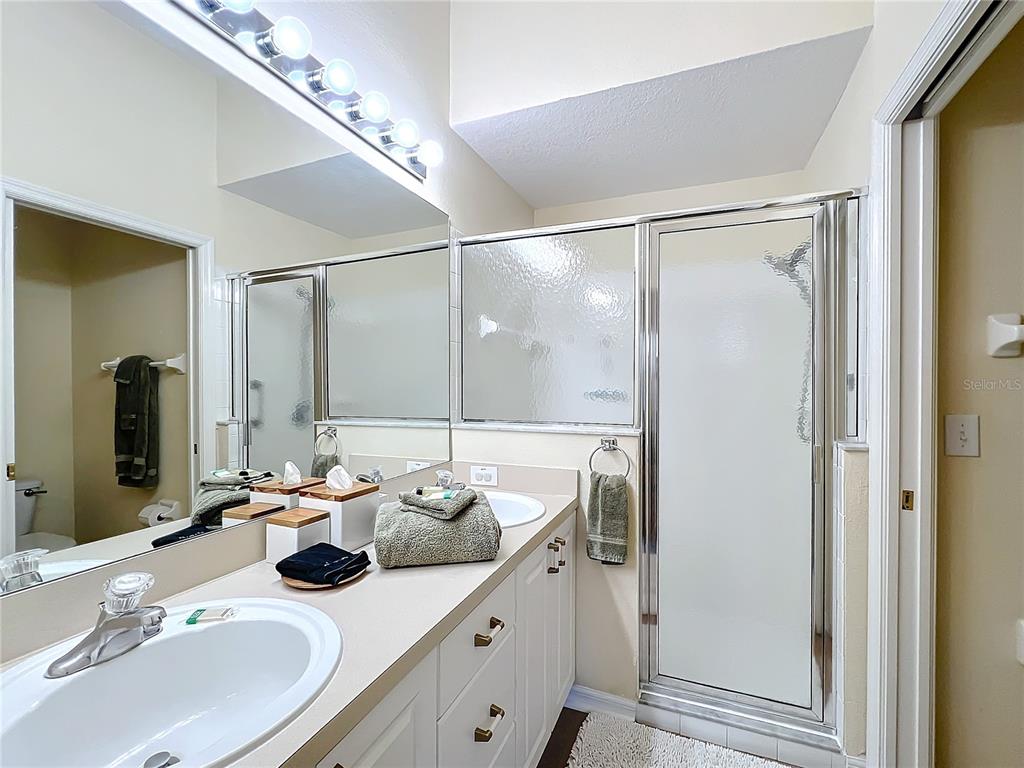 802 Brunello Drive Davenport, FL 33897 - Photo 24 of 36 a bathroom with a sink and a mirror