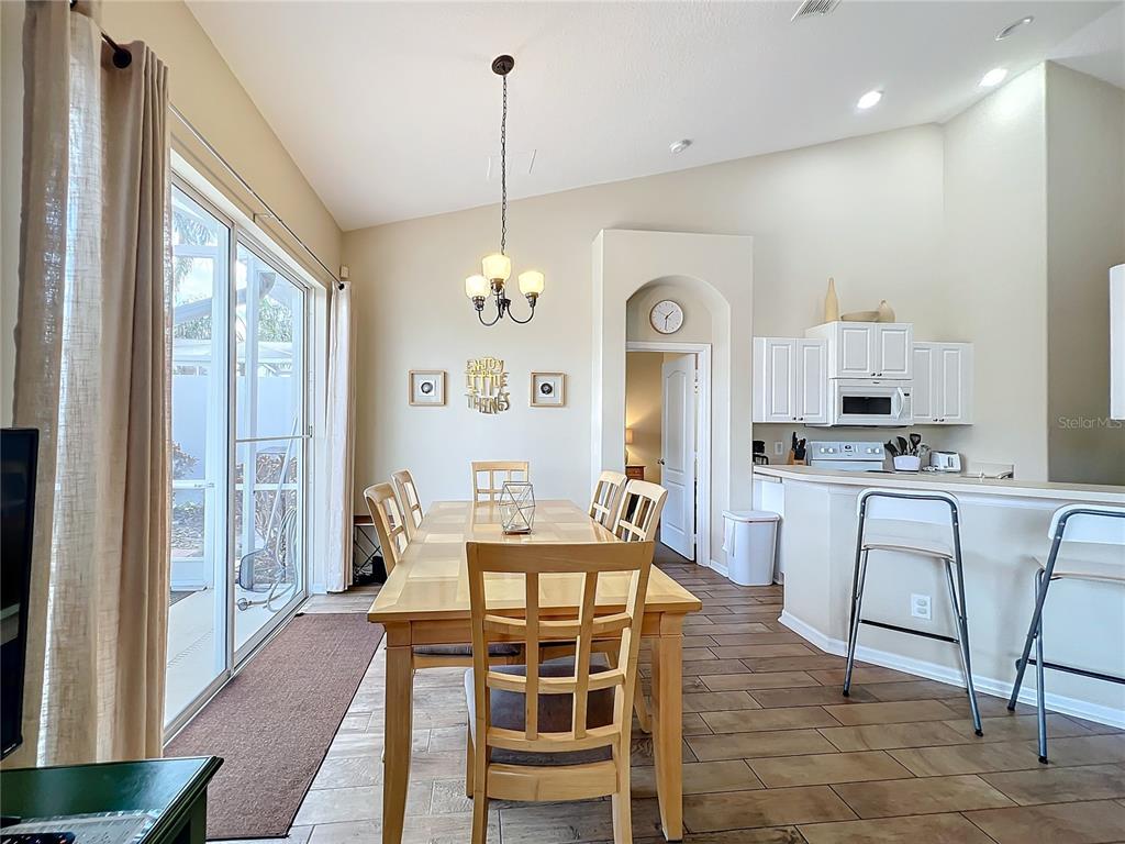 802 Brunello Drive Davenport, FL 33897 - Photo 6 of 36 a view of a dining room with furniture window and wooden floor