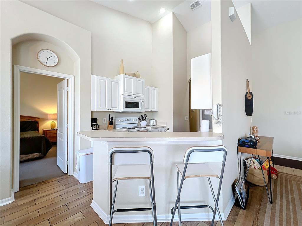 802 Brunello Drive Davenport, FL 33897 - Photo 9 of 36 a kitchen with stainless steel appliances a stove a sink and a refrigerator