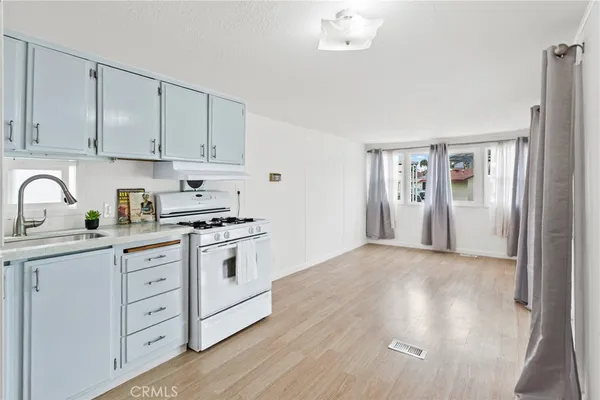 a kitchen with white cabinets and white appliances