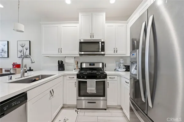 a kitchen with a sink stove and microwave