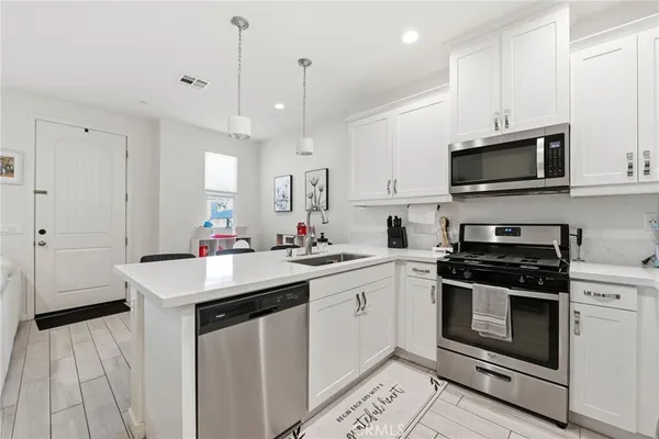 a kitchen with sink cabinets and living room view