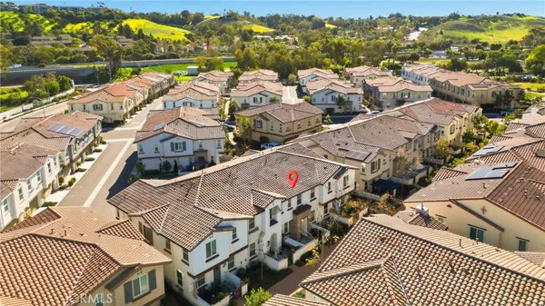 an aerial view of residential building with parking