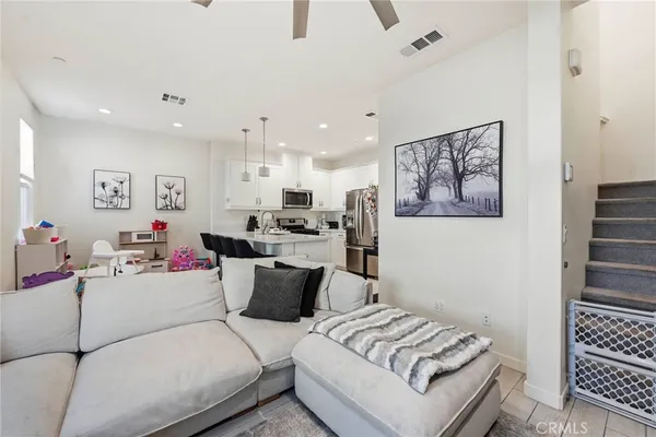 a kitchen with kitchen island a refrigerator stove and microwave
