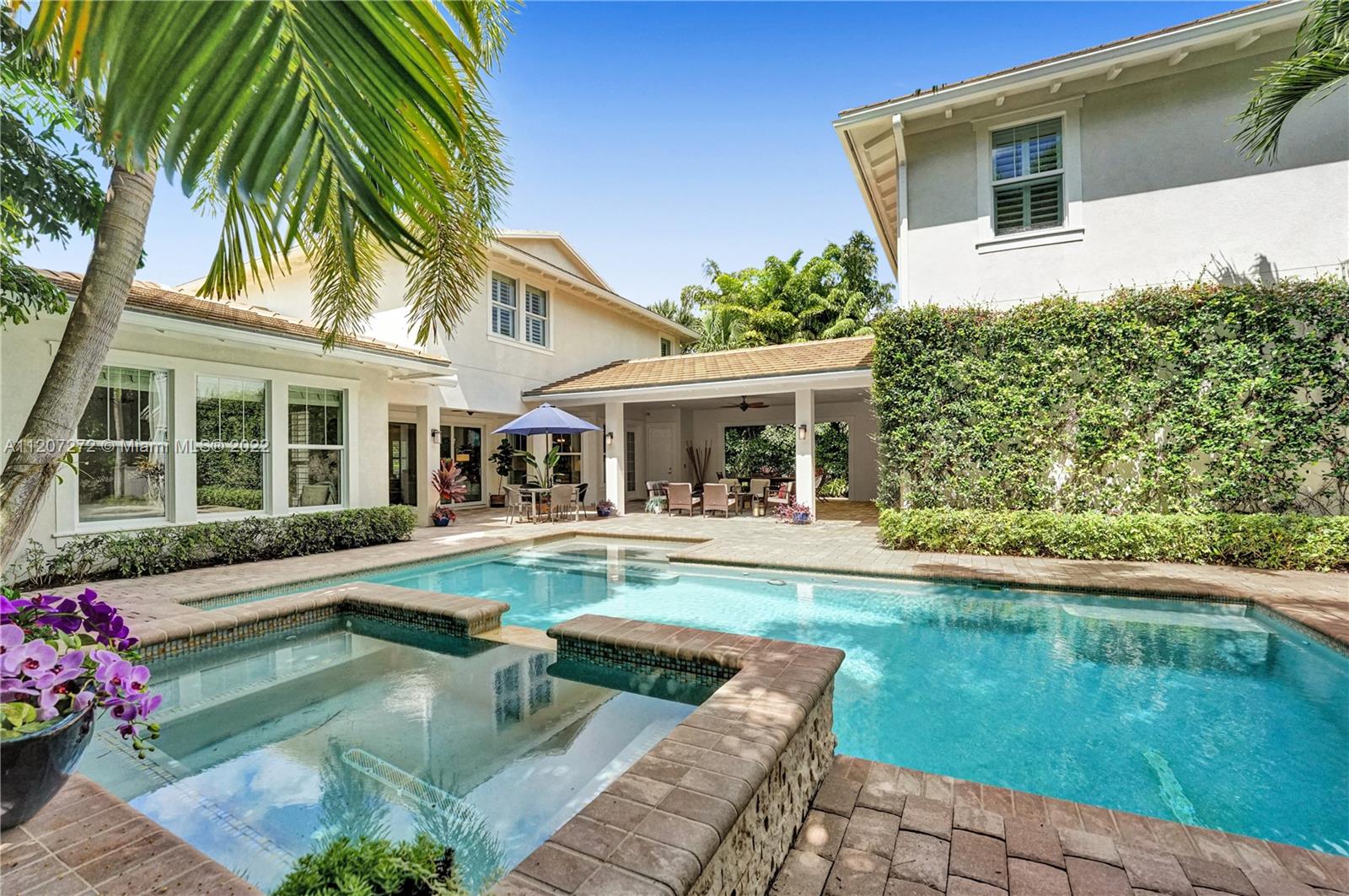 1055 Frederick Small Road Jupiter, FL 33458 - Photo 2 of 48 a house with swimming pool in front of it