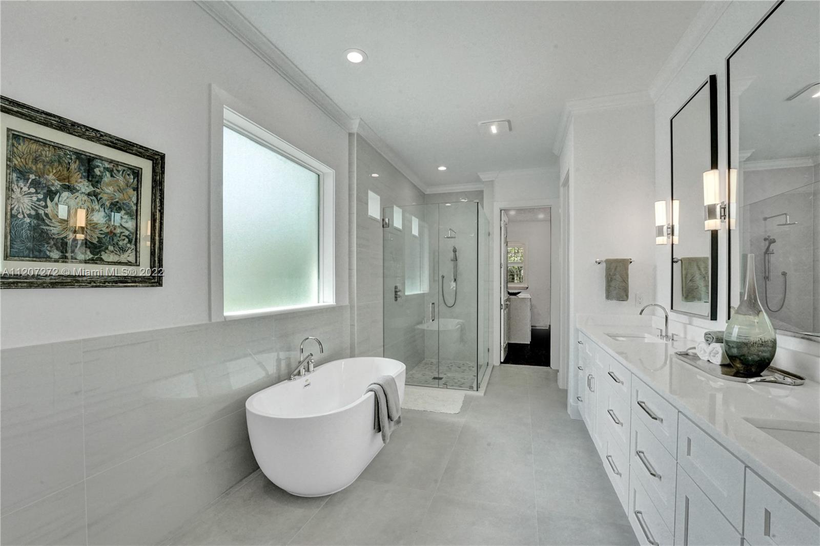 1055 Frederick Small Road Jupiter, FL 33458 - Photo 22 of 48 a bathroom with a double vanity sink and a mirror