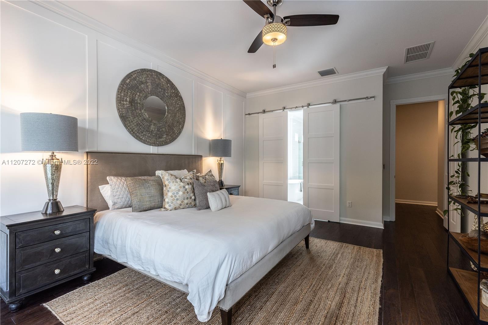 1055 Frederick Small Road Jupiter, FL 33458 - Photo 23 of 48 a bedroom with a bed and a chandelier