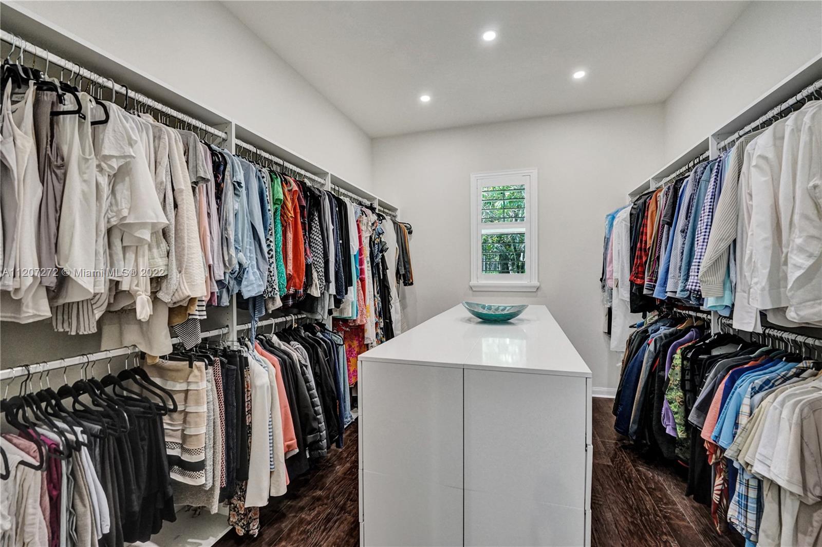 1055 Frederick Small Road Jupiter, FL 33458 - Photo 25 of 48 a view of walk in closet with clothes and shoes