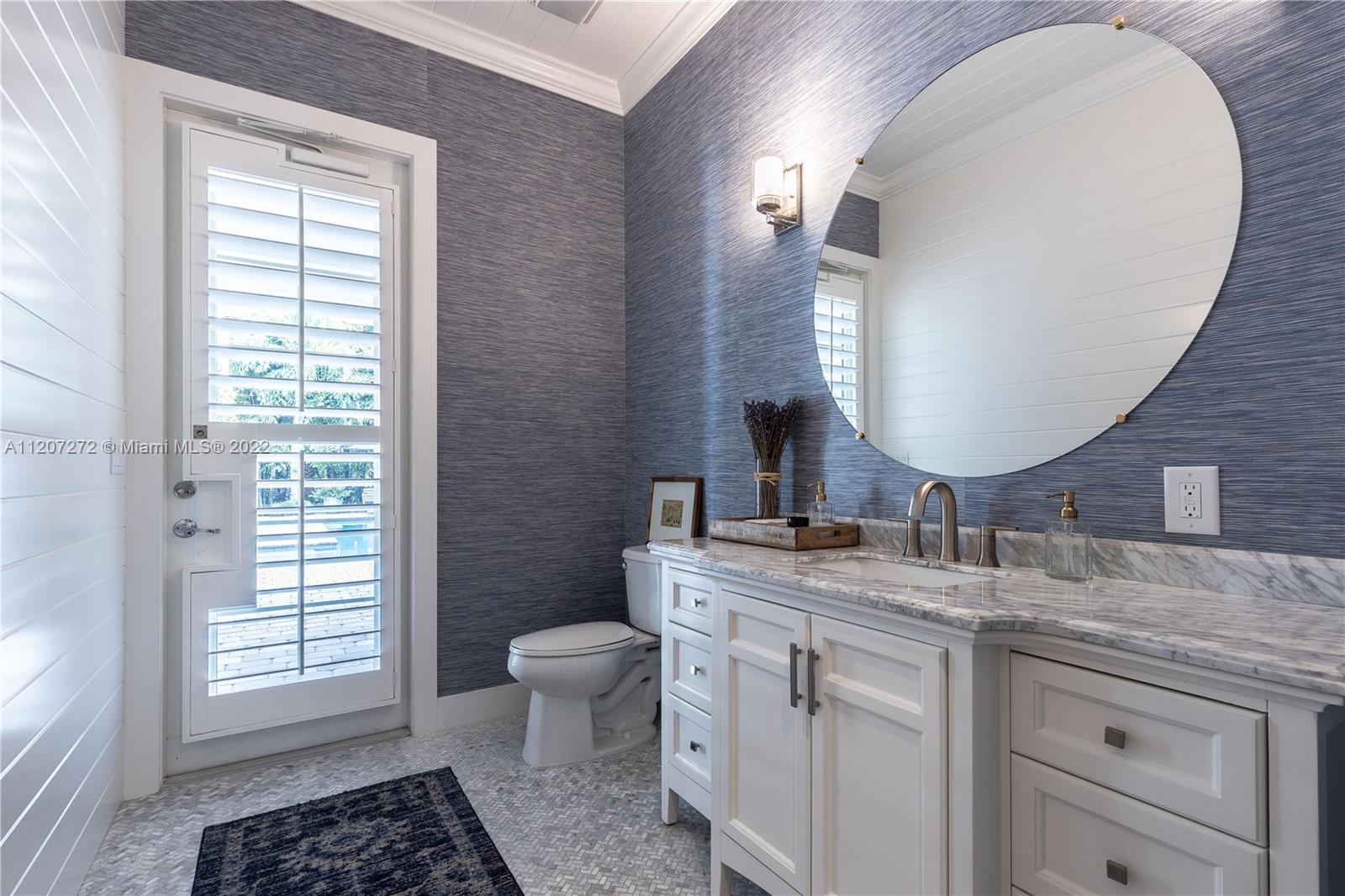 1055 Frederick Small Road Jupiter, FL 33458 - Photo 27 of 48 a bathroom with a granite countertop toilet a sink and a mirror