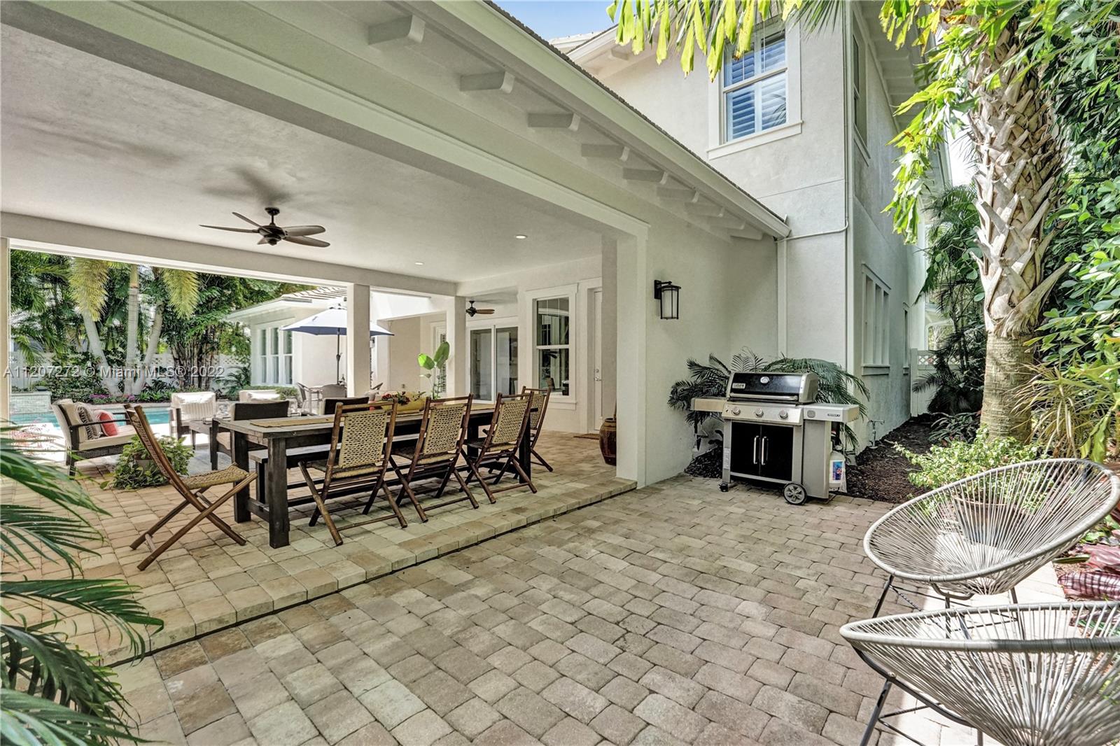 1055 Frederick Small Road Jupiter, FL 33458 - Photo 44 of 48 a outdoor space with lots of chairs a rug and a chandelier