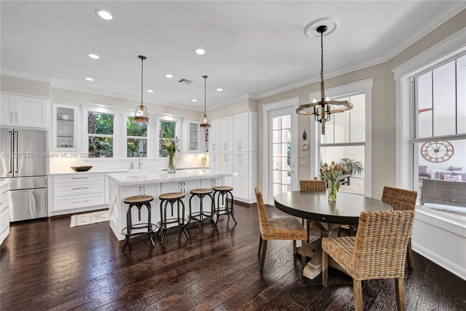 1055 Frederick Small Road Jupiter, FL 33458 - Photo 8 of 48 a dining room with furniture a chandelier and wooden floor