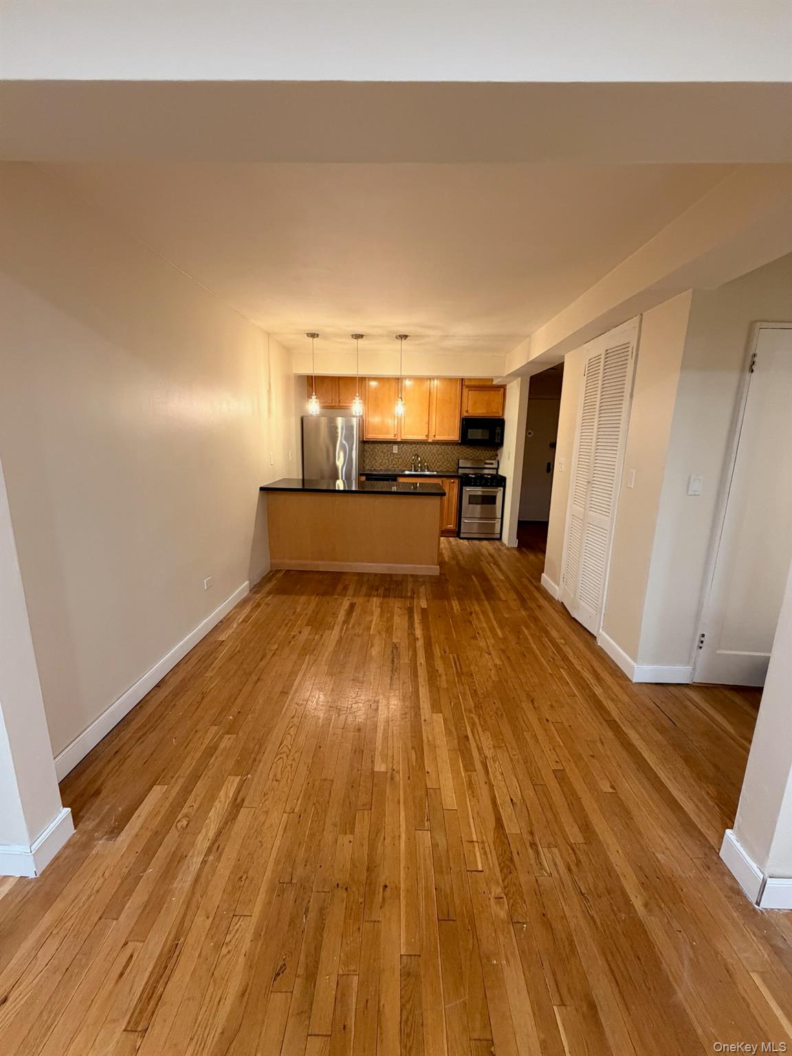67-th Rd 10245th Queens, NY 11375 - Photo 4 of 6 a view of a room with wooden floor