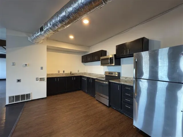 a kitchen with stainless steel appliances a refrigerator and a sink