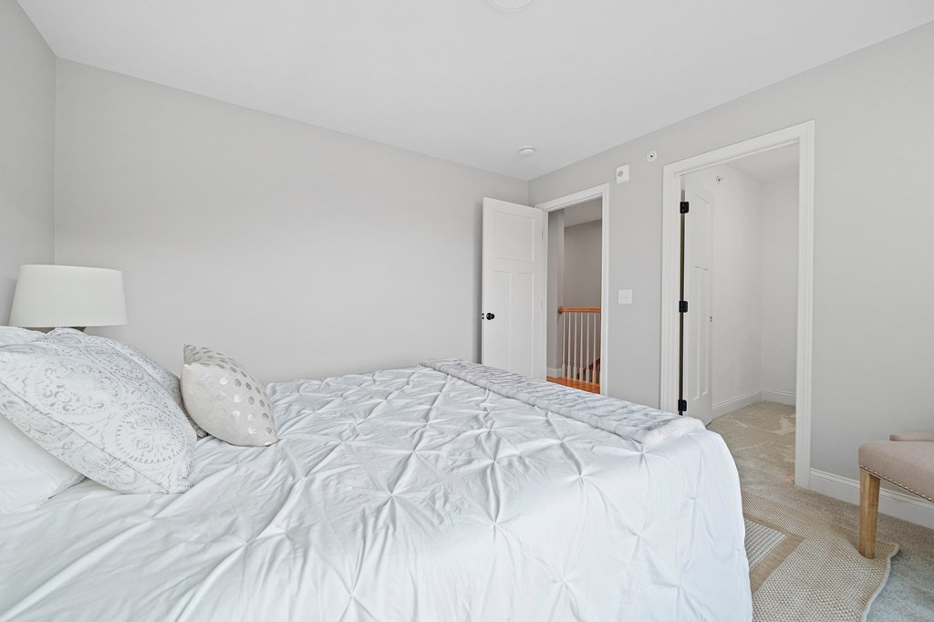 30 Old Washington Street, Unit 9 Pembroke, MA 02359 - Photo 11 of 21 a bedroom with a bed and a cabinets