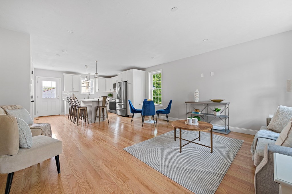 30 Old Washington Street, Unit 9 Pembroke, MA 02359 - Photo 2 of 21 a living room with furniture a table and wooden floor