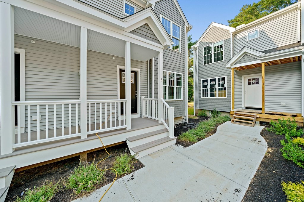30 Old Washington Street, Unit 9 Pembroke, MA 02359 - Photo 21 of 21 a view of a house with a small yard and wooden floor and fence