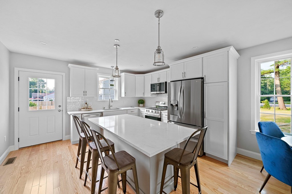 30 Old Washington Street, Unit 9 Pembroke, MA 02359 - Photo 4 of 21 a view of a dining room with furniture window and wooden floor