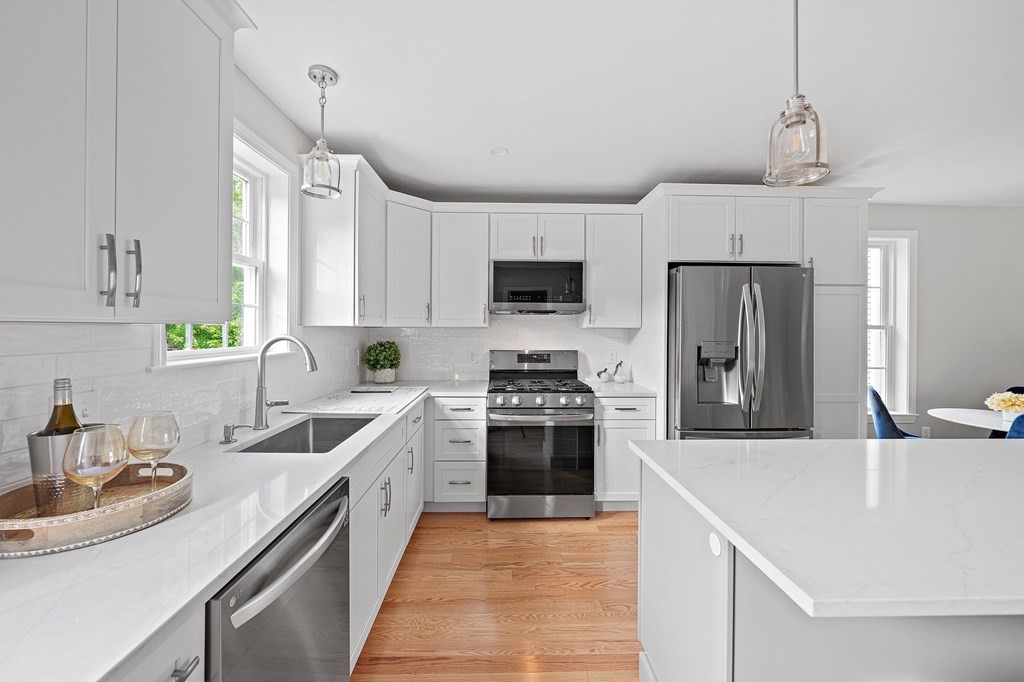 30 Old Washington Street, Unit 9 Pembroke, MA 02359 - Photo 5 of 21 a kitchen with kitchen island a sink appliances and cabinets