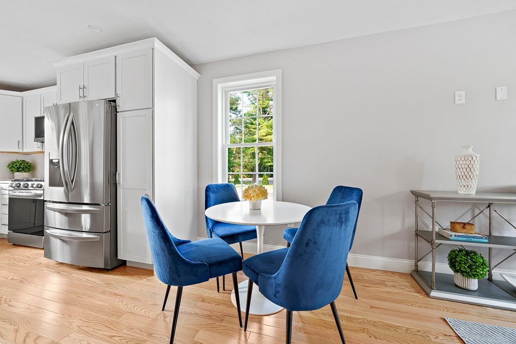 30 Old Washington Street, Unit 9 Pembroke, MA 02359 - Photo 8 of 21 a view of a dining room with furniture a rug and wooden floor