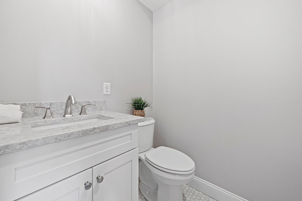30 Old Washington Street, Unit 9 Pembroke, MA 02359 - Photo 9 of 21 a bathroom with a granite countertop toilet and sink