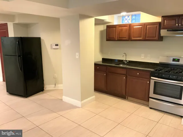 a kitchen with stainless steel appliances a sink and a refrigerator