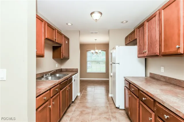 a kitchen with stainless steel appliances granite countertop a stove a refrigerator and a sink