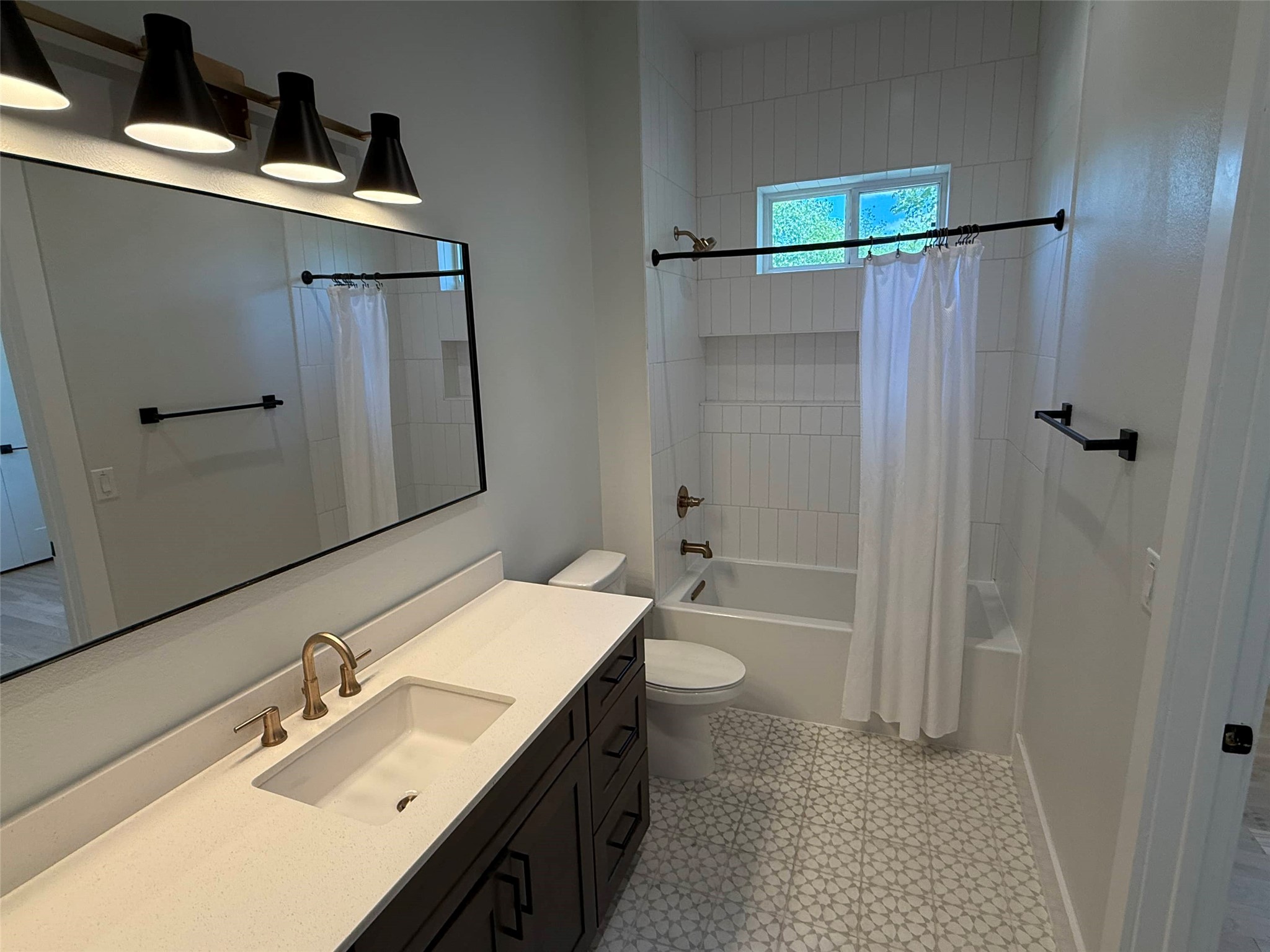 3509 Oak Springs Drive, Unit A Austin, TX 78721 - Photo 13 of 16 a bathroom with a sink toilet and shower