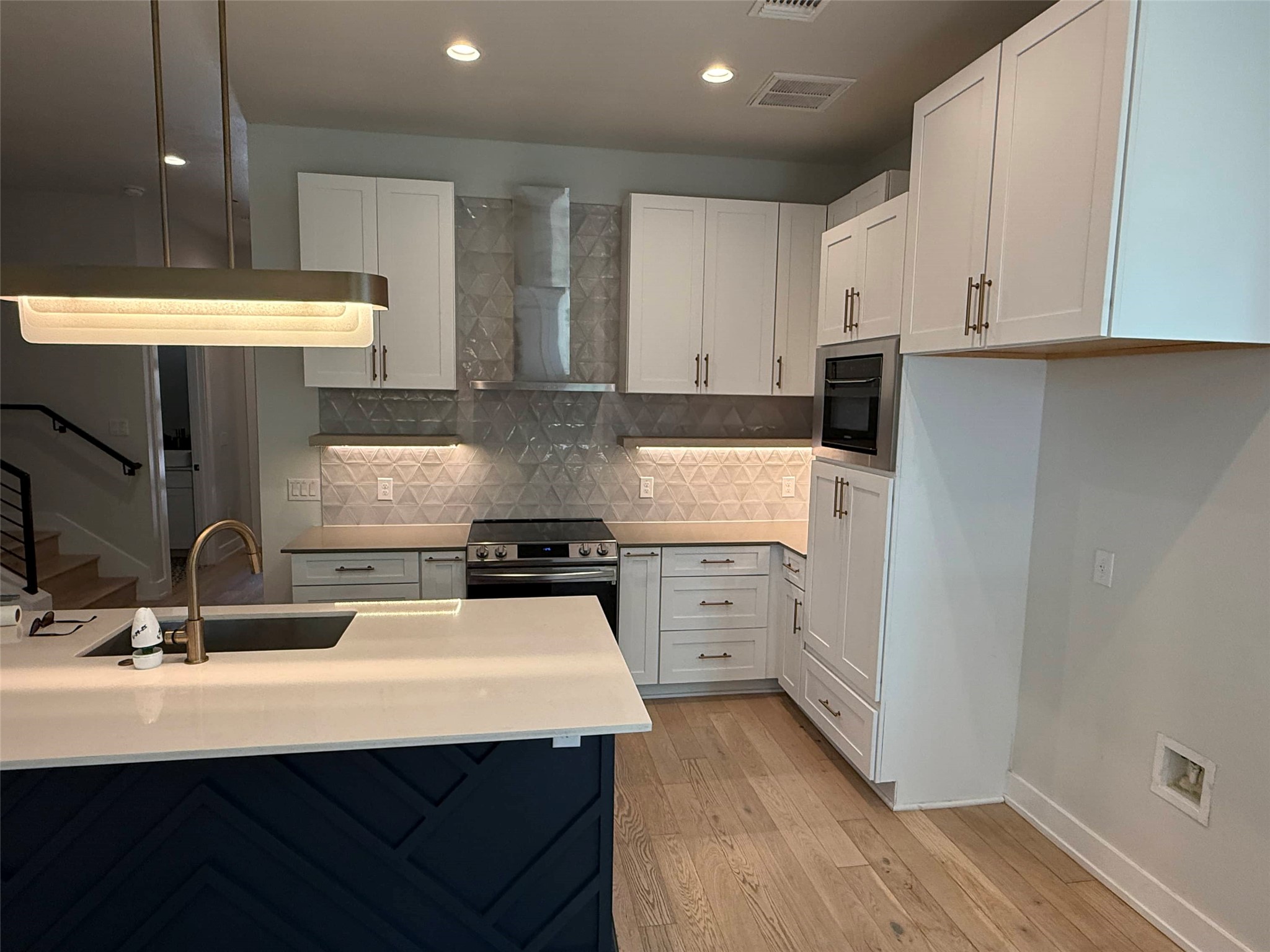 3509 Oak Springs Drive, Unit A Austin, TX 78721 - Photo 3 of 16 a kitchen with a sink a stove and cabinets