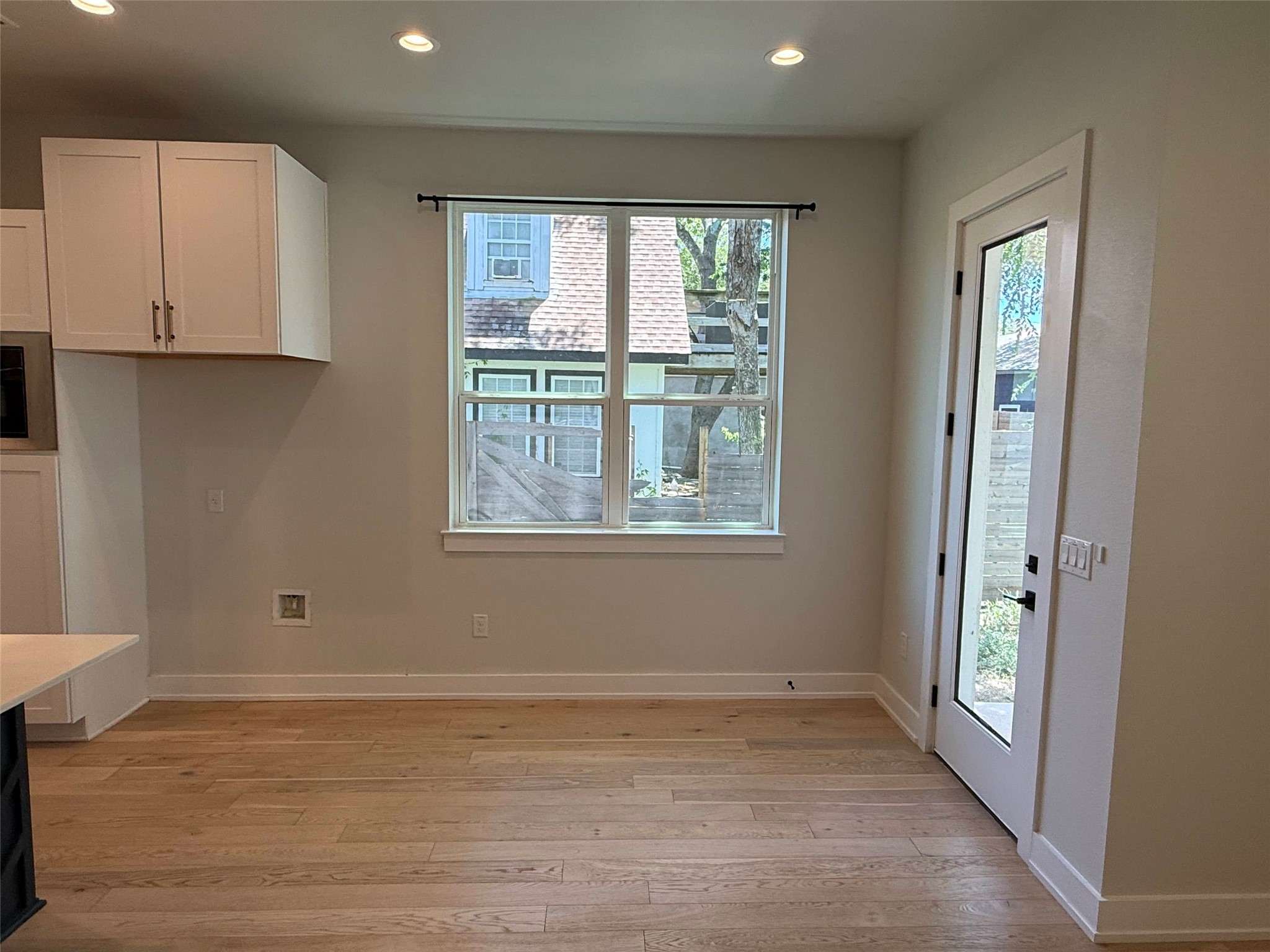 3509 Oak Springs Drive, Unit A Austin, TX 78721 - Photo 6 of 16 a view of an empty room with wooden floor and a window
