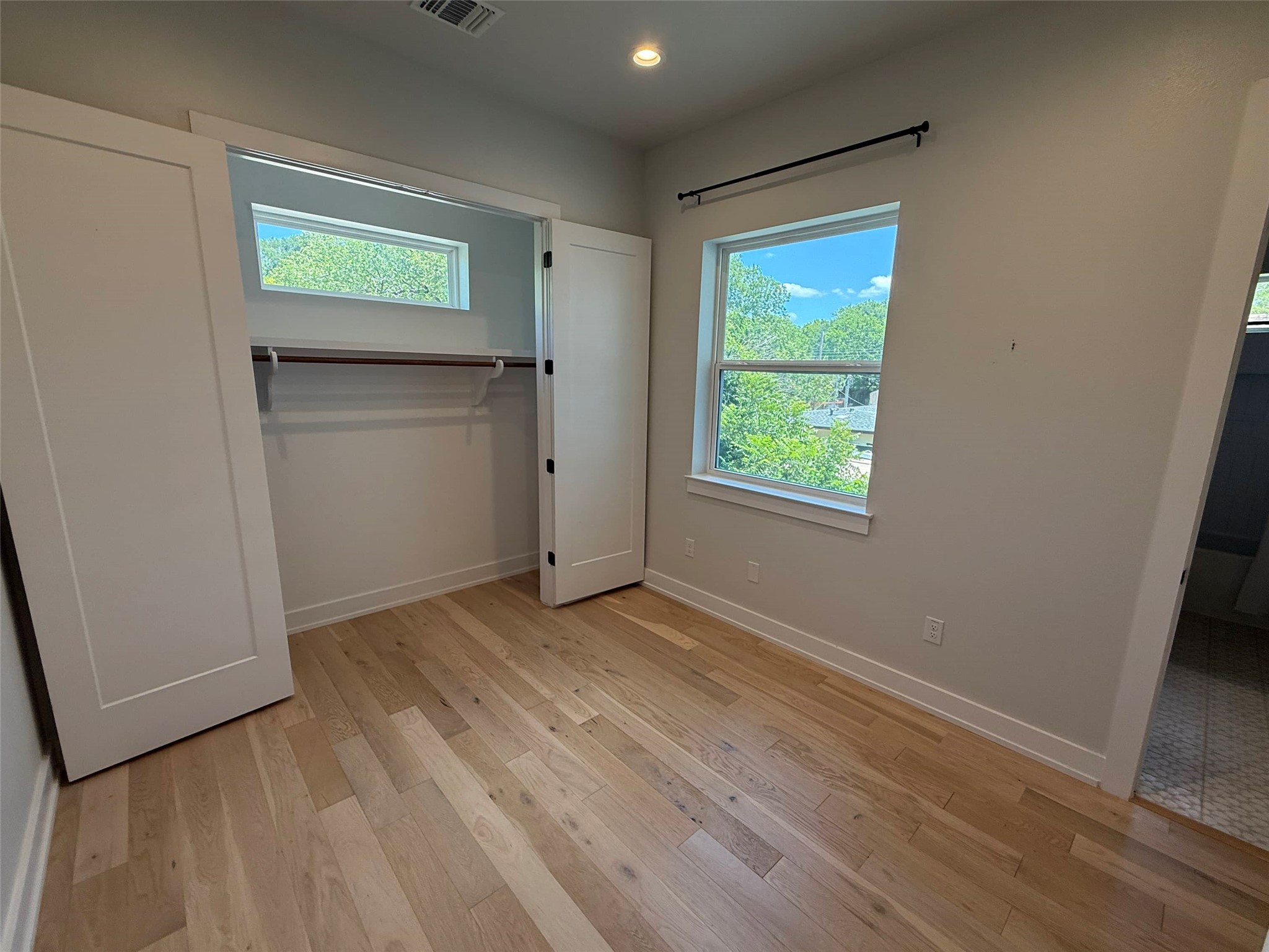 3509 Oak Springs Drive, Unit A Austin, TX 78721 - Photo 10 of 16 an empty room with windows and closet