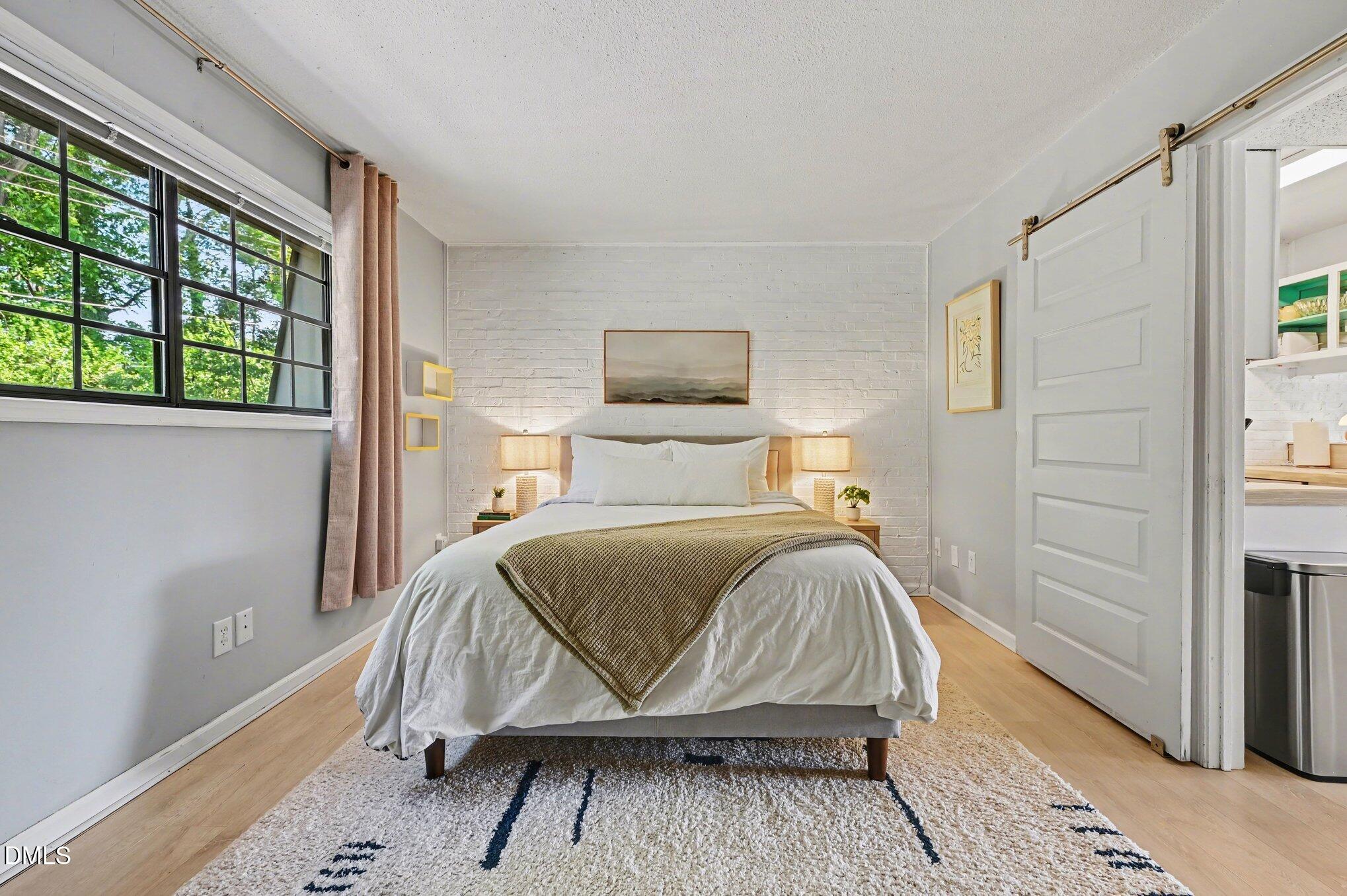 807 West Trinity Avenue, Unit 252 Durham, NC 27701 - Photo 10 of 23 a bedroom with a bed and a window