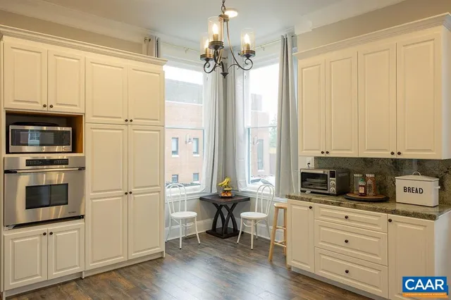 a kitchen with granite countertop a stove and a refrigerator