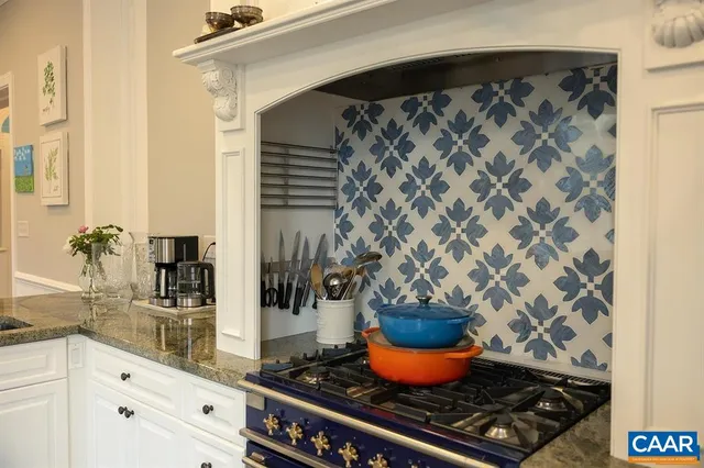 a kitchen with stainless steel appliances kitchen island granite countertop a refrigerator and a sink