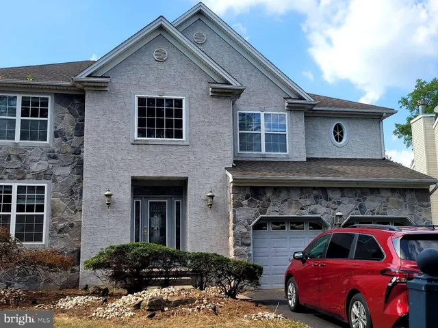a front view of a house with parking space