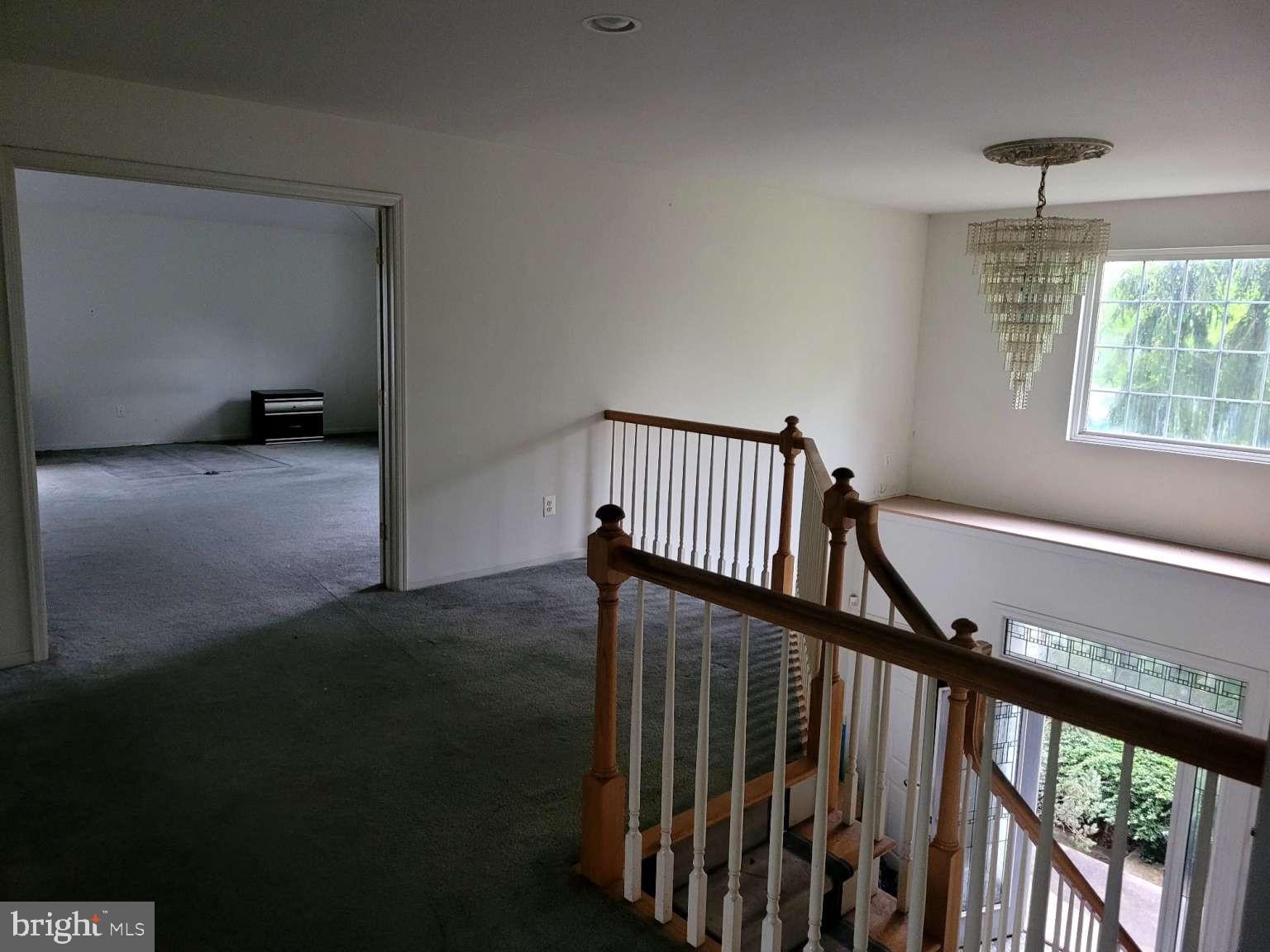 9 Jimarie Court Hamilton, NJ 08620 - Photo 11 of 20 a view of a hallway with wooden floor and staircase