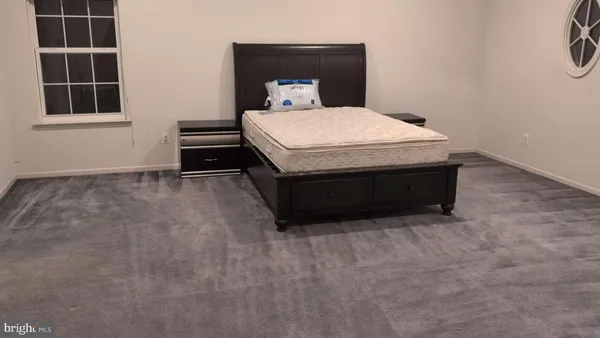 a room with a bed and window