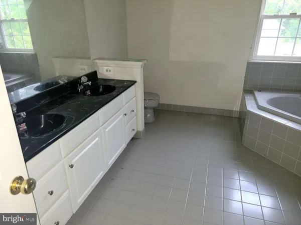 a kitchen with a stove and white cabinets