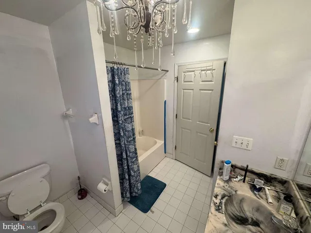 a bathroom with a toilet and shower