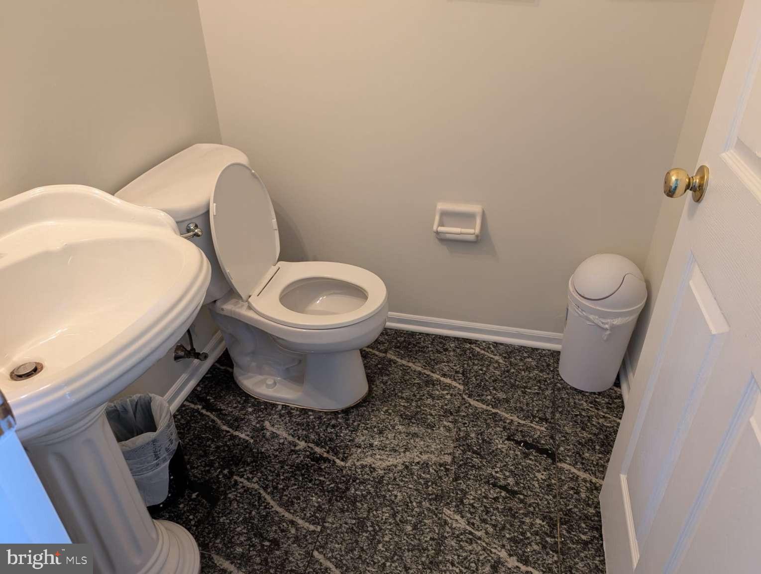 9 Jimarie Court Hamilton, NJ 08620 - Photo 3 of 20 a white toilet sitting next to a sink