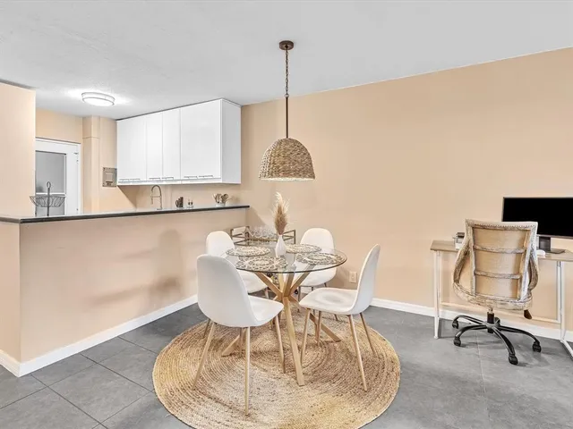 a dining room with furniture and a chandelier
