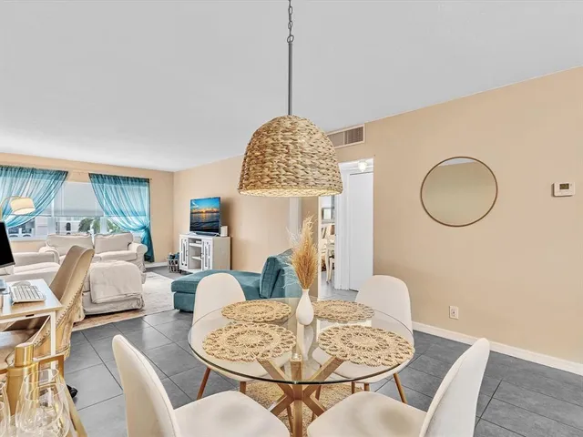 a living room with furniture a table and a large window