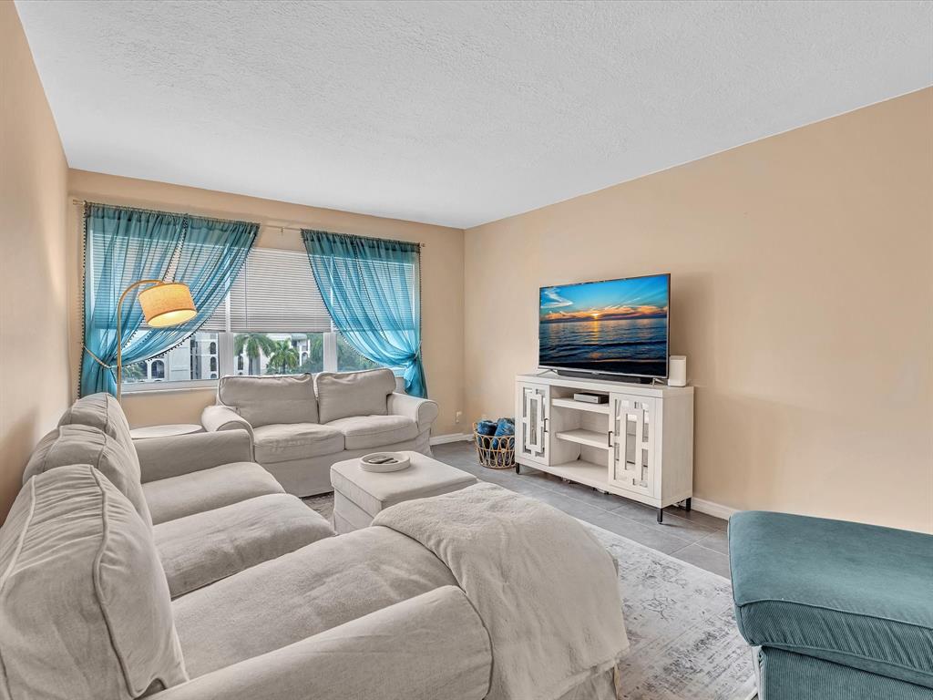 2555 Northeast 11th Street, Unit 610 Fort Lauderdale, FL 33304 - Photo 19 of 33 a living room with furniture and a flat screen tv