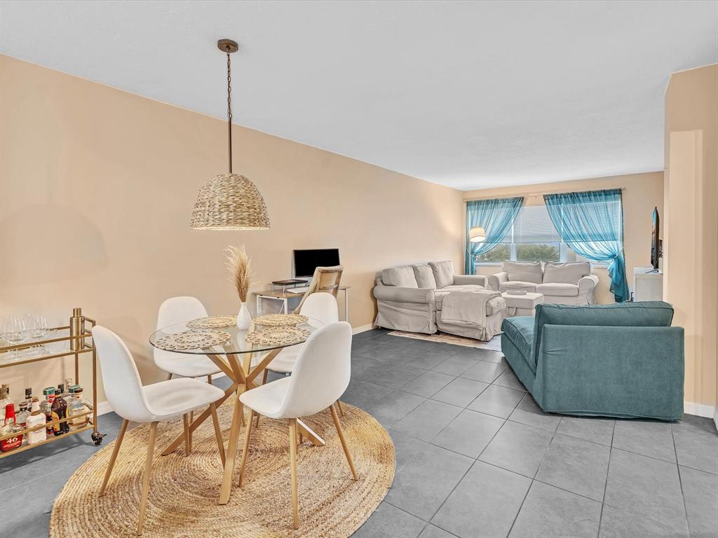 2555 Northeast 11th Street, Unit 610 Fort Lauderdale, FL 33304 - Photo 2 of 33 a living room with furniture and a chandelier