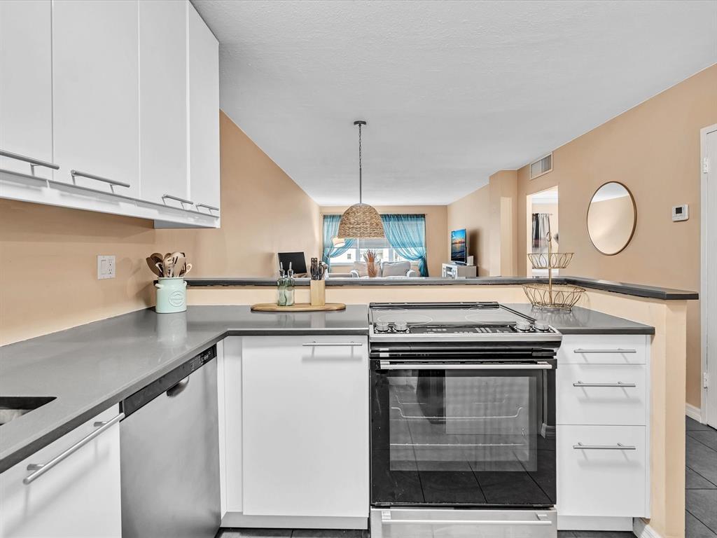 2555 Northeast 11th Street, Unit 610 Fort Lauderdale, FL 33304 - Photo 7 of 33 a kitchen with stainless steel appliances granite countertop a stove a sink and a microwave