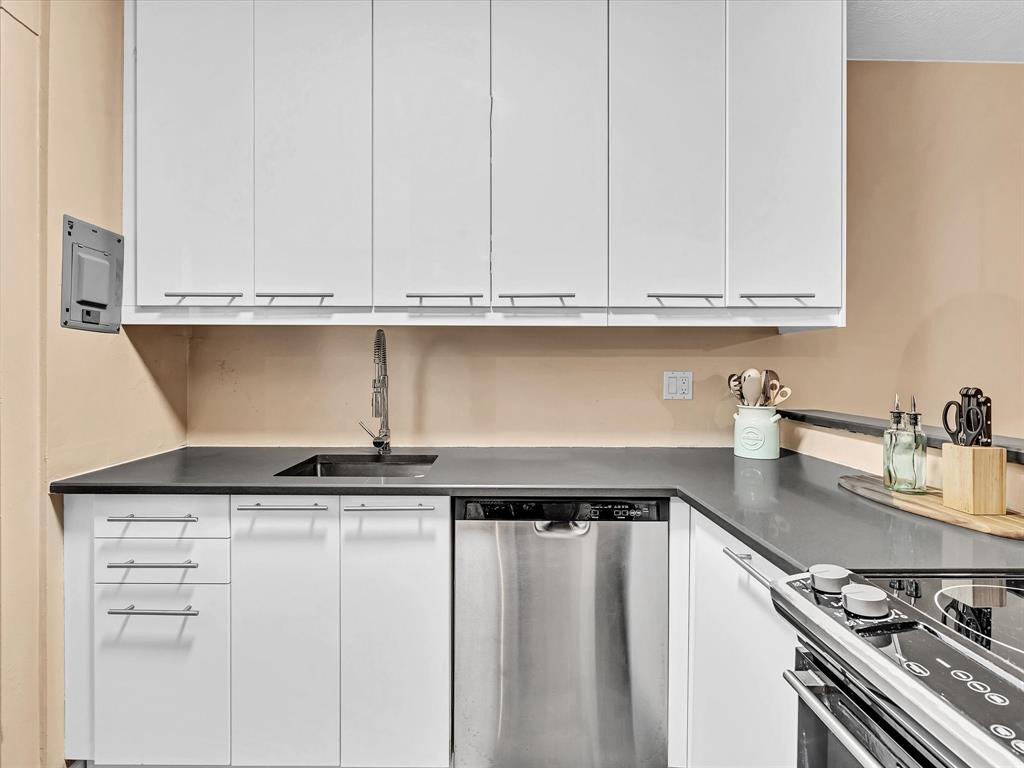 2555 Northeast 11th Street, Unit 610 Fort Lauderdale, FL 33304 - Photo 8 of 33 a kitchen with granite countertop a sink and cabinets