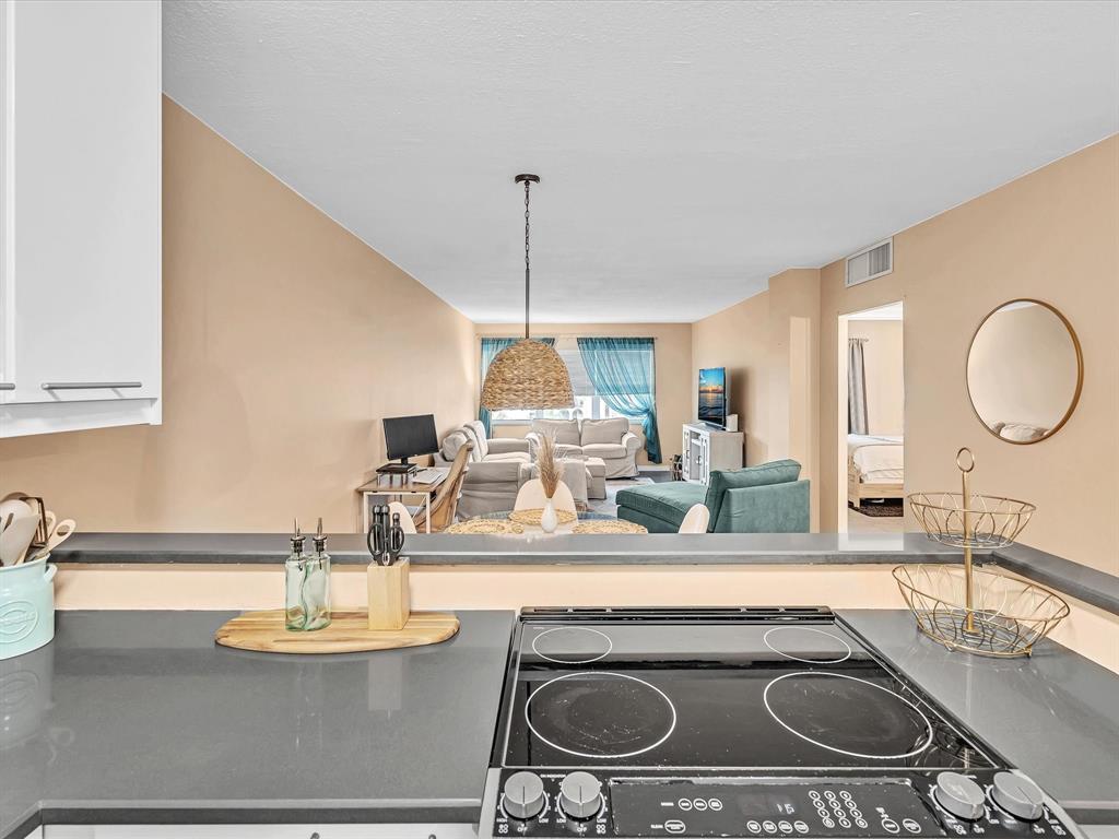 2555 Northeast 11th Street, Unit 610 Fort Lauderdale, FL 33304 - Photo 9 of 33 a kitchen with a stove and a sink with wooden floor