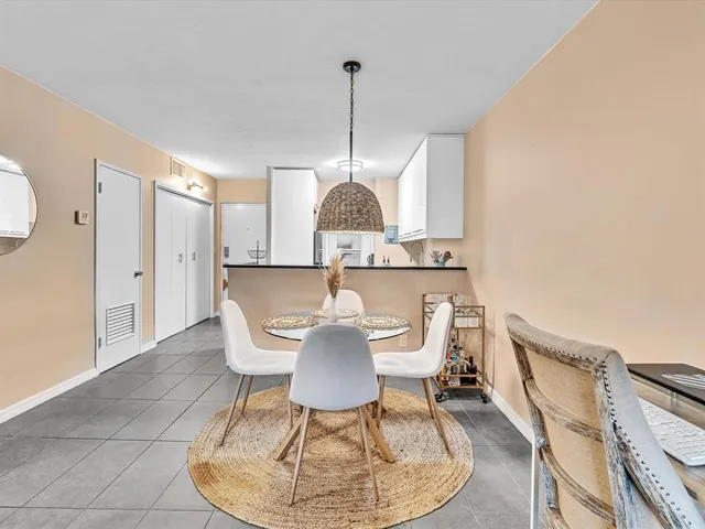 a dining room with furniture and a chandelier