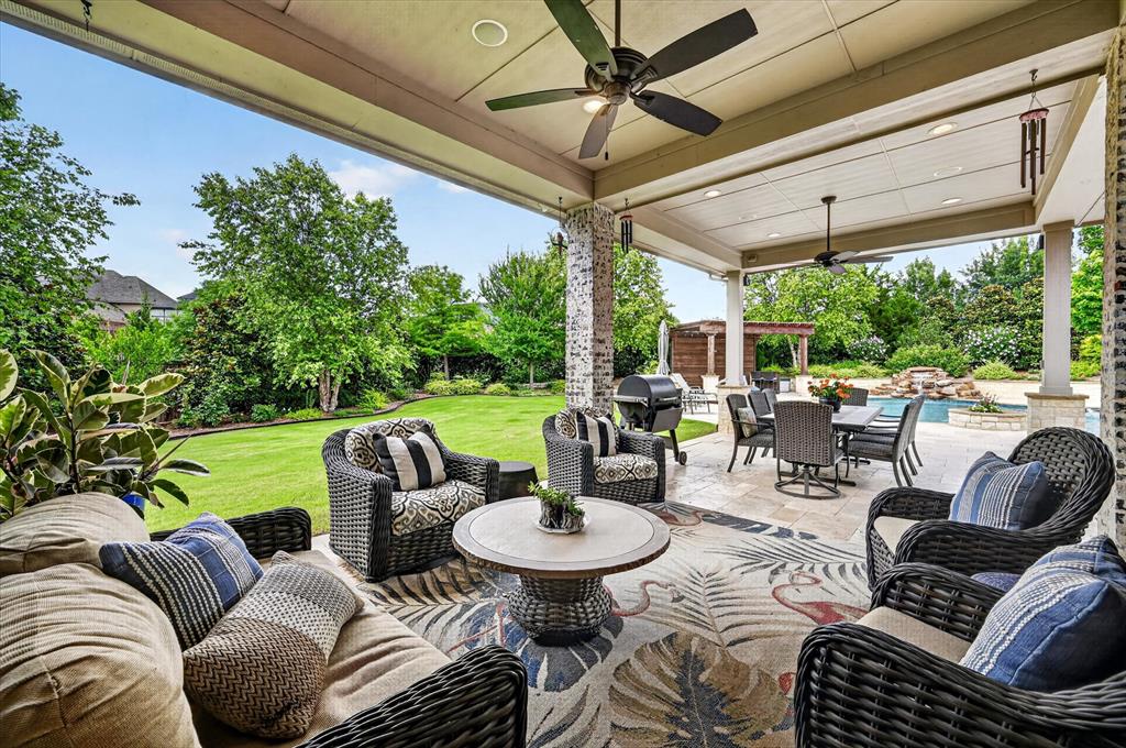6656 Roughleaf Ridge Road Flower Mound, TX 76226 - Photo 2 of 40 a living room with patio furniture and a garden