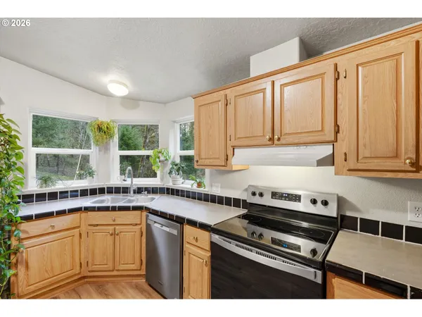 a kitchen with a sink stove and cabinets