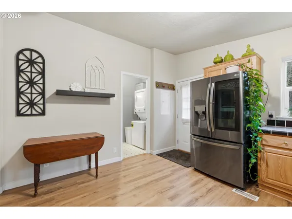 a kitchen with stainless steel appliances granite countertop a refrigerator and a stove top oven
